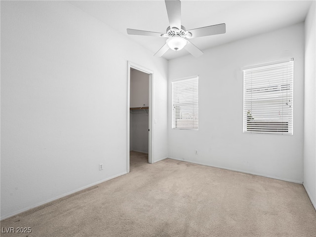 empty room featuring light colored carpet and ceiling fan