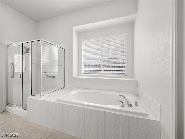 bathroom featuring tile patterned flooring and separate shower and tub