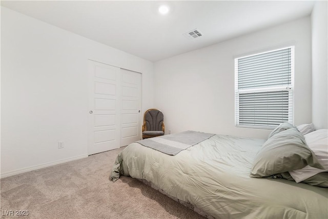 carpeted bedroom featuring a closet