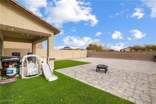 view of yard with a patio and a fire pit