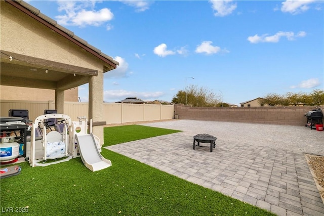 view of yard featuring a patio area and an outdoor fire pit