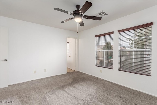 carpeted empty room featuring ceiling fan