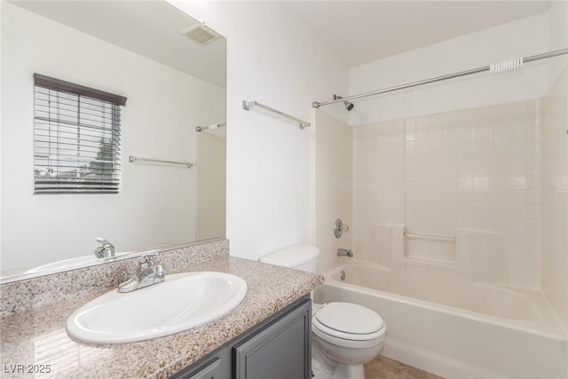 full bathroom with bathtub / shower combination, vanity, and toilet