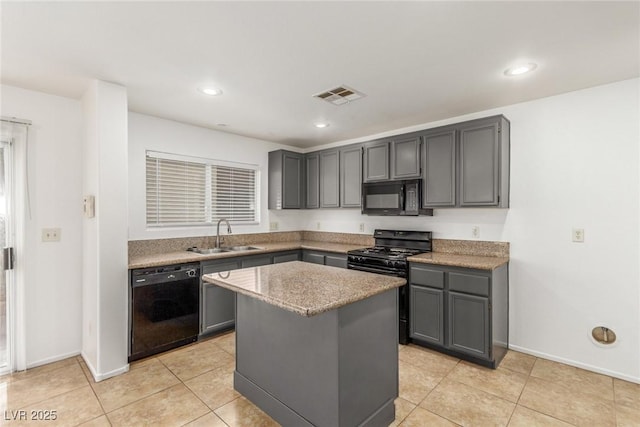 kitchen featuring gray cabinets, a kitchen island, sink, and black appliances