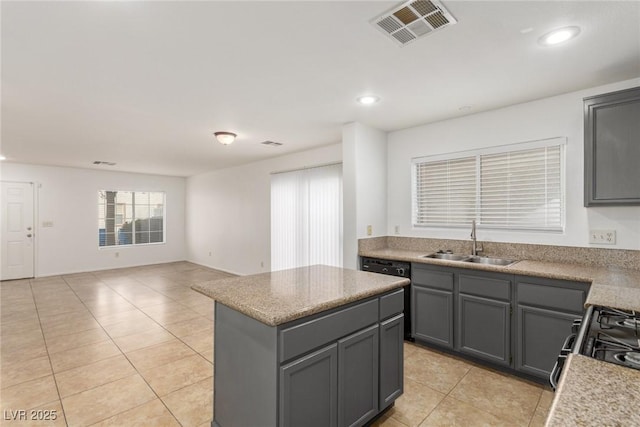 kitchen featuring gray cabinets, a kitchen island, sink, light tile patterned floors, and black appliances