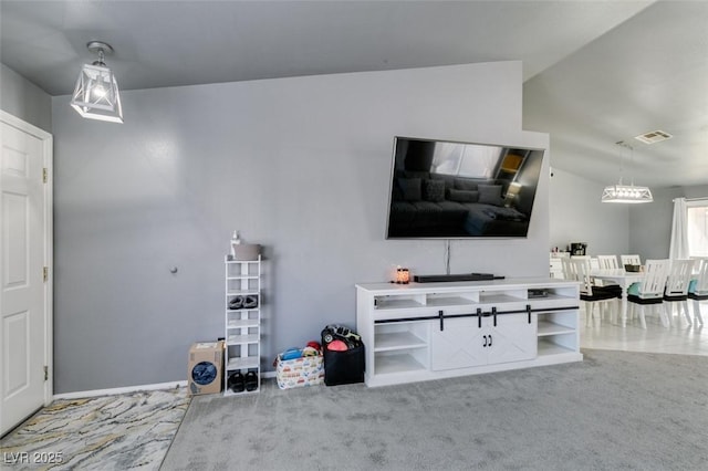 unfurnished living room featuring vaulted ceiling and carpet flooring