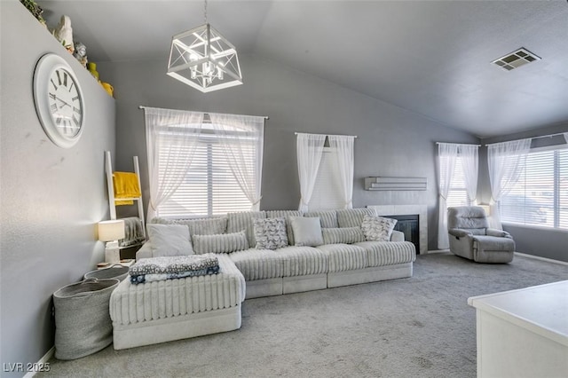 carpeted living room with vaulted ceiling and a notable chandelier