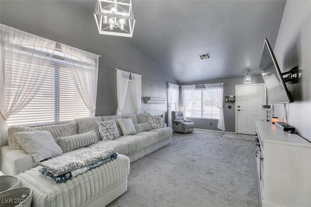 carpeted living room featuring a chandelier and high vaulted ceiling