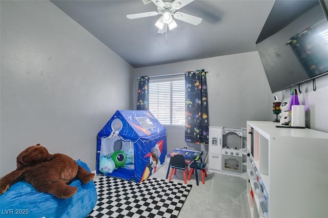 playroom with lofted ceiling, carpet flooring, and ceiling fan