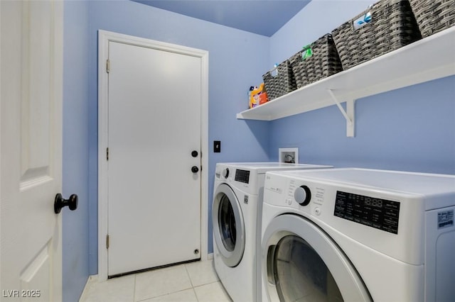 laundry room featuring light tile patterned flooring and washing machine and clothes dryer