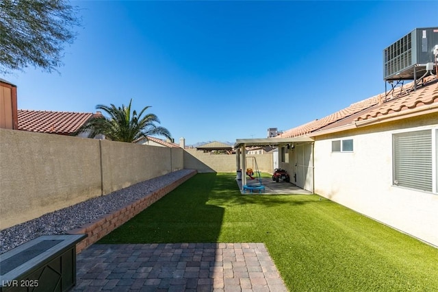 view of yard featuring a patio and central air condition unit