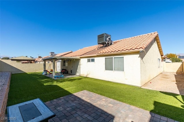 back of property featuring central AC, a yard, and a patio area