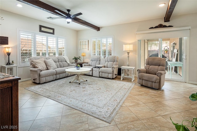 living room with ceiling fan, plenty of natural light, and beam ceiling