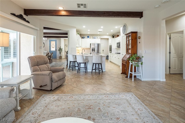 living room featuring sink and beam ceiling