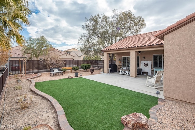 view of yard with ceiling fan and a patio