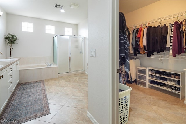 bathroom featuring tile patterned floors, separate shower and tub, and vanity