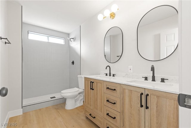 bathroom featuring walk in shower, vanity, toilet, and hardwood / wood-style floors