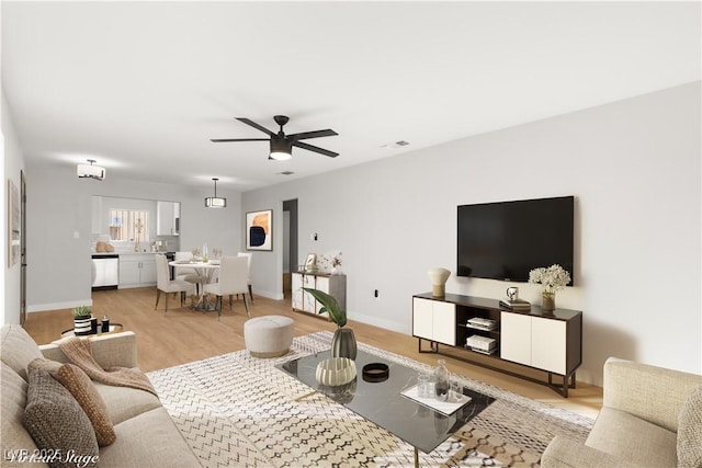 living room featuring ceiling fan and light hardwood / wood-style floors