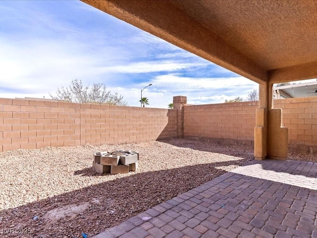 view of patio with an outdoor fire pit and a fenced backyard