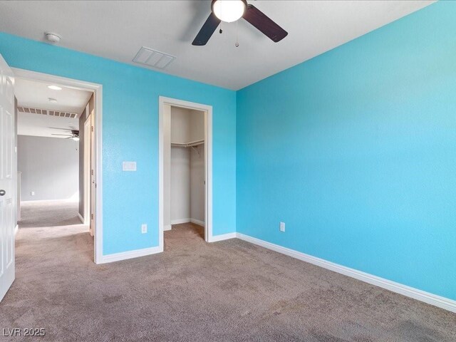 unfurnished bedroom with light carpet, baseboards, visible vents, and a closet