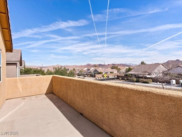 balcony featuring a residential view and a mountain view