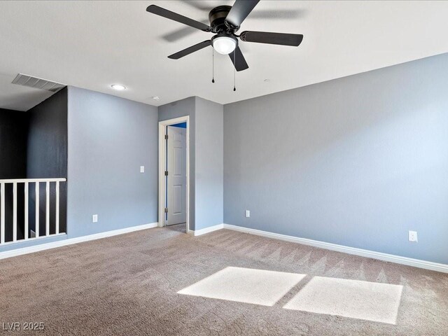 spare room with baseboards, visible vents, ceiling fan, and carpet flooring