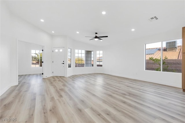 unfurnished living room featuring ceiling fan, vaulted ceiling, and light hardwood / wood-style flooring