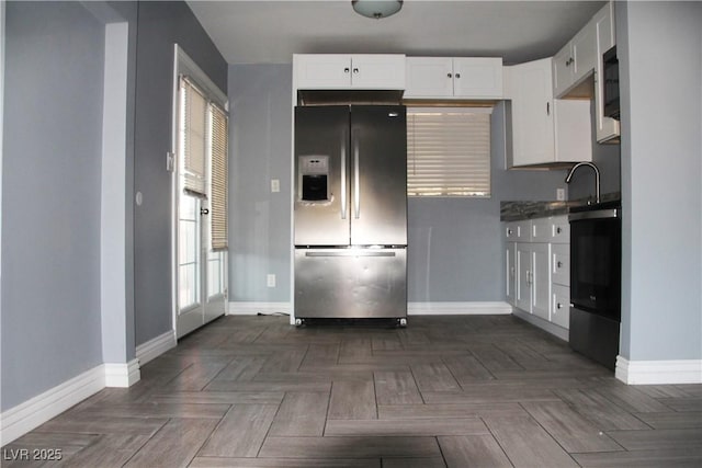 kitchen featuring white cabinetry, sink, dark parquet flooring, stainless steel fridge with ice dispenser, and electric stove