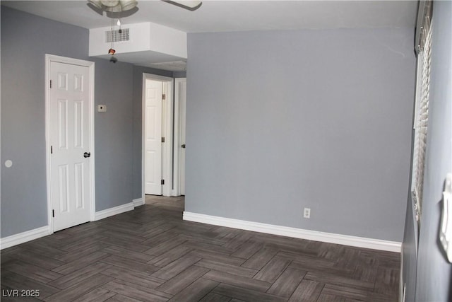 unfurnished bedroom featuring dark parquet flooring