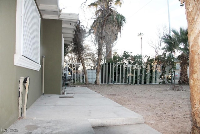 view of gate featuring a patio area