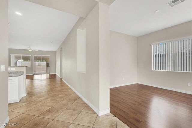 hall featuring light tile patterned flooring