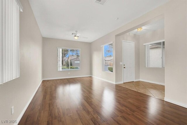 empty room featuring ceiling fan and hardwood / wood-style floors