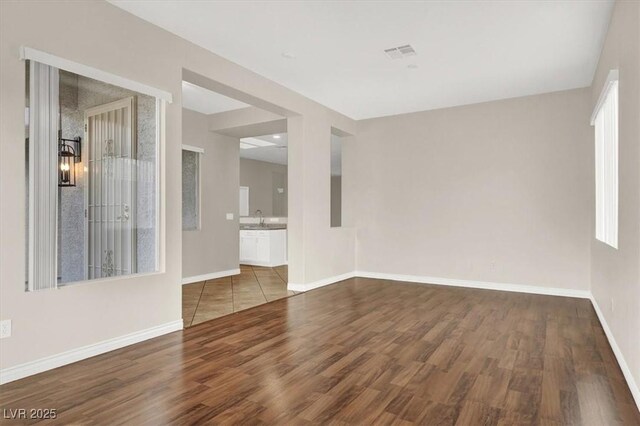 empty room with sink and hardwood / wood-style flooring