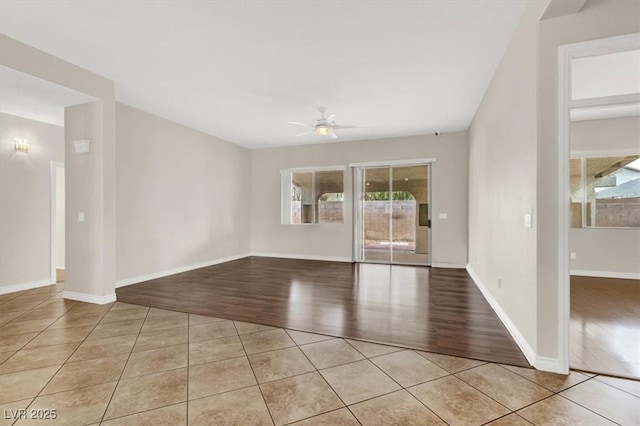 tiled spare room with ceiling fan