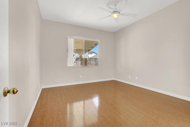 empty room featuring wood-type flooring and ceiling fan