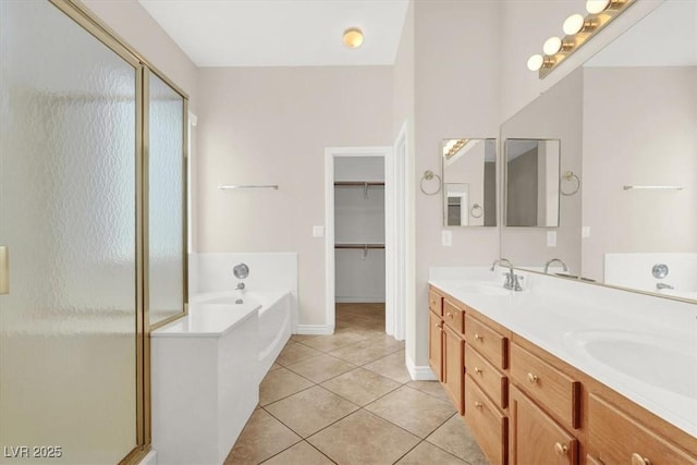 bathroom with tile patterned floors, independent shower and bath, and vanity