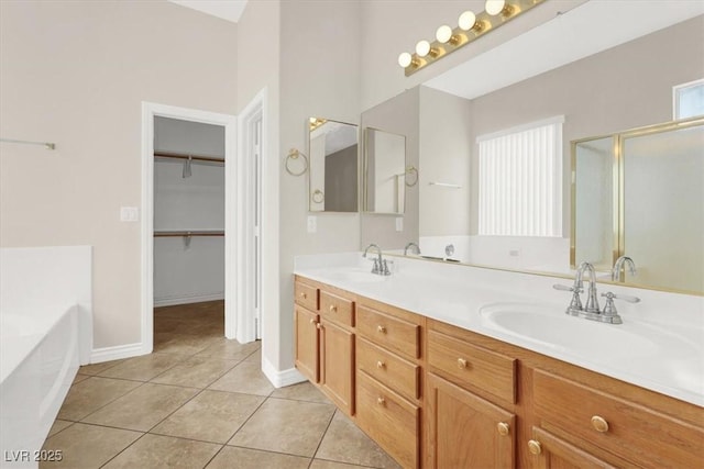 bathroom featuring tile patterned floors, plus walk in shower, and vanity