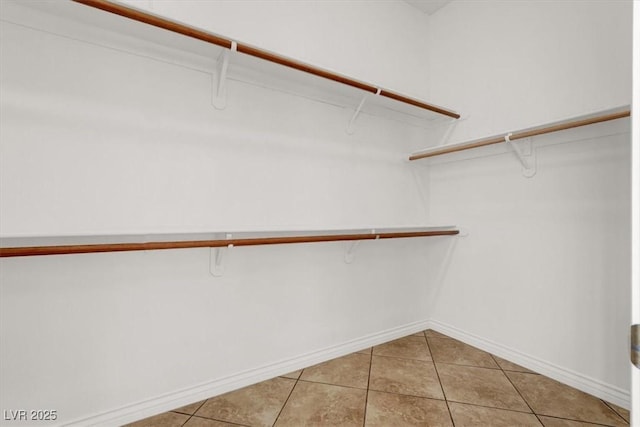 spacious closet with light tile patterned flooring