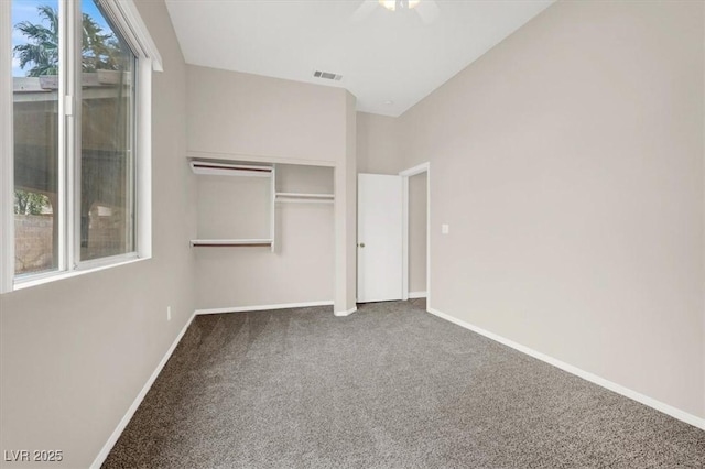 unfurnished bedroom featuring carpet floors, a closet, and lofted ceiling