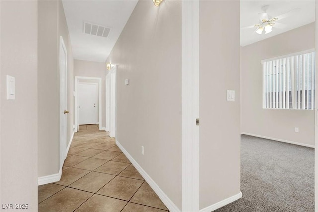 hallway with light tile patterned floors