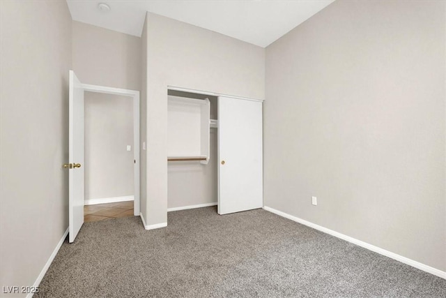 unfurnished bedroom with carpet and a closet