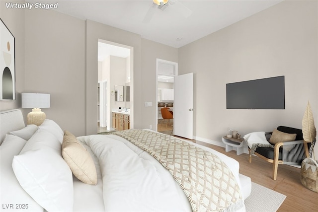 bedroom with ensuite bath and wood-type flooring