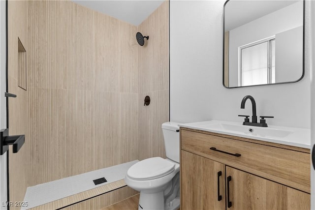 bathroom with walk in shower, vanity, and toilet