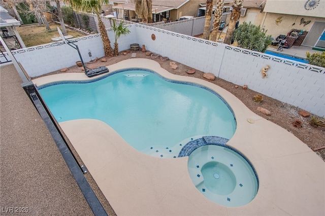 view of swimming pool featuring an in ground hot tub