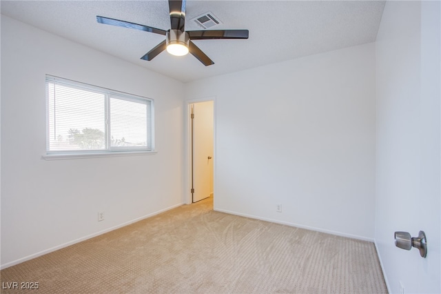 unfurnished room with ceiling fan and light carpet