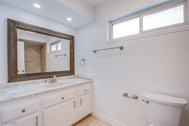 bathroom featuring vanity, a wealth of natural light, tile patterned floors, and toilet