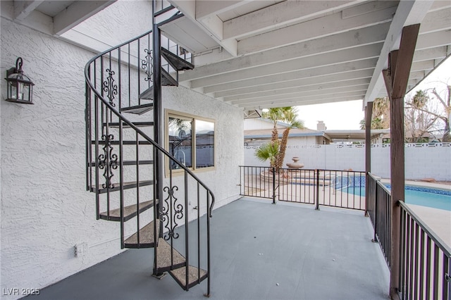 view of patio with a fenced in pool