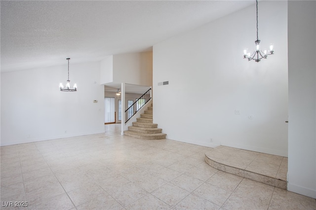 tiled empty room featuring ceiling fan with notable chandelier, a textured ceiling, and high vaulted ceiling