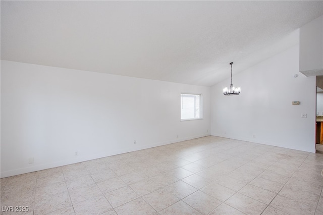 tiled spare room with lofted ceiling and an inviting chandelier