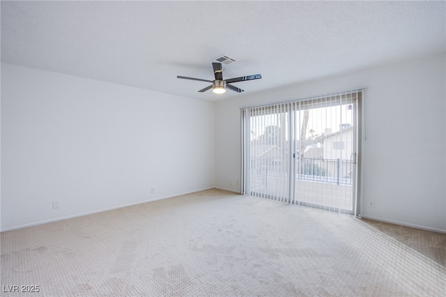 carpeted empty room with a textured ceiling and ceiling fan